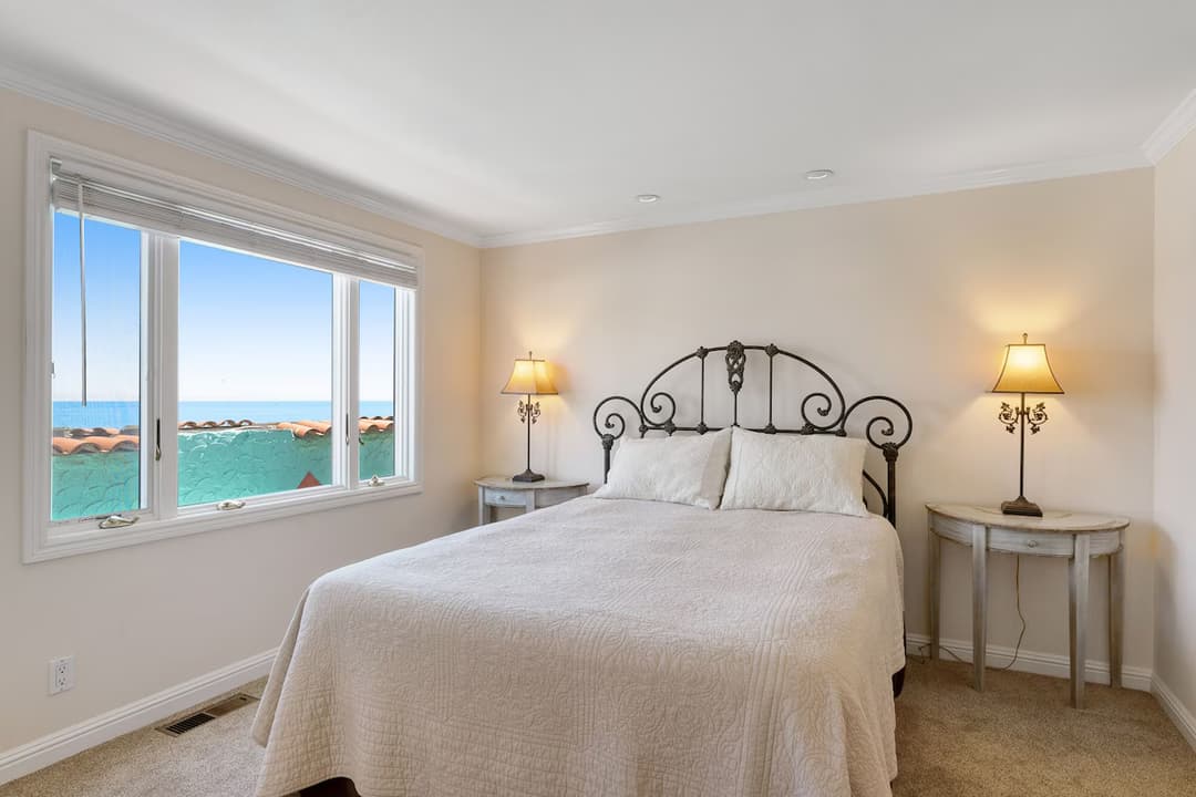 picture of a master bedroom overlooking the ocean in a Capitola beachfront luxury venetian home